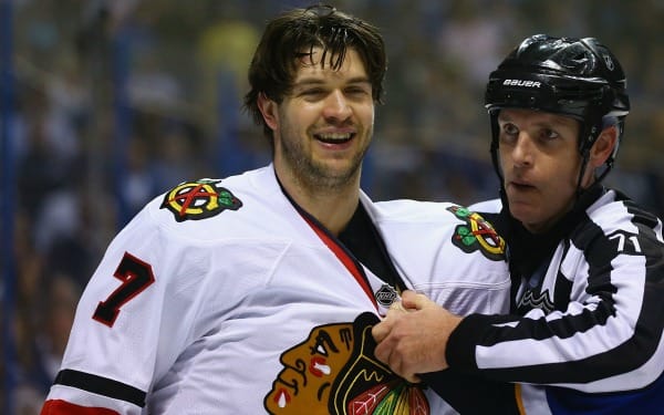 Brent Seabrook is restrained by a referee after lying out David Backes. (Dilip Vishwanat/Getty Images)